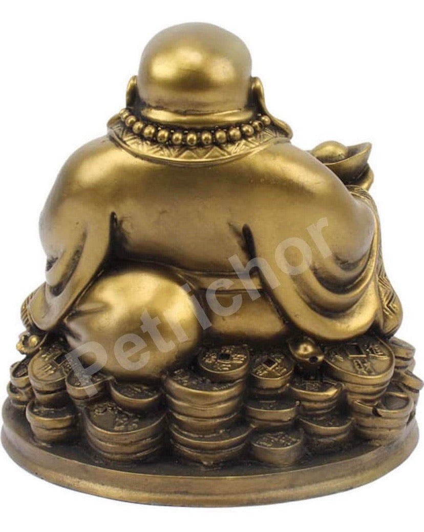 Laughing Buddha Sitting on Lucky Money Coins